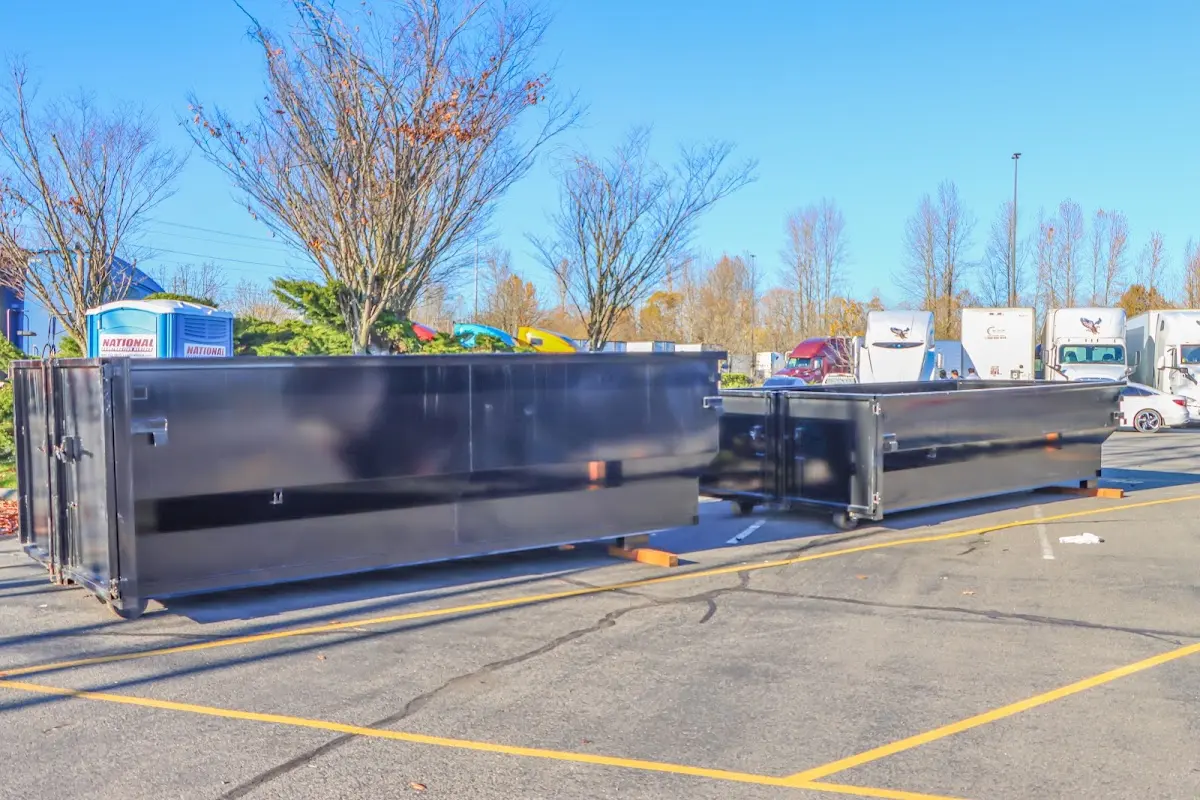 Professional dumpster rental service with roll-off container on residential driveway in Waldwick